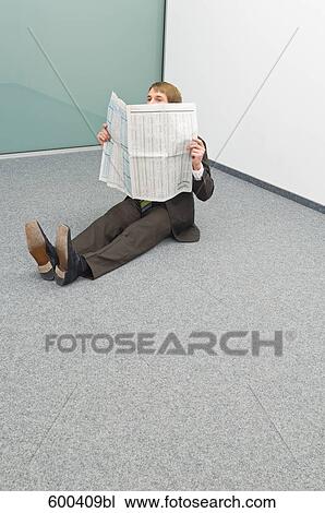 businessman sitting in corner reading newspaper View Large Photo Image Stock Image - businessman sitting in corner reading newspaper. Fotosearch