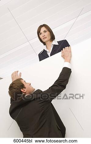 businessman trying to climb up to female colleage View Large Photo Image Stock Image - businessman trying to climb up to female colleage. Fotosearch