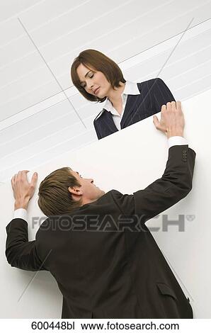 businessman trying to climb up to female colleage View Large Photo Image Stock Image - businessman trying to climb up to female colleage. Fotosearch