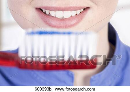 close-up of medical assistant holding large toothbrush View Large Photo Image Stock Image - close-up of medical assistant holding large toothbrush. Fotosearch
