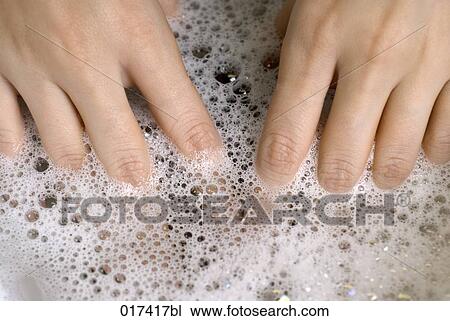 Stock Image - close-up of woman bathing her hands. Fotosearch