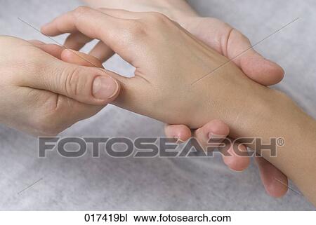 Stock Image - close-up of woman getting hand massage. Fotosearch