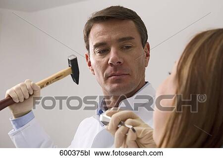 dentist treating female patient with hammer and chisel View Large Photo Image Stock Image - dentist treating female patient with hammer and chisel. Fotosearch