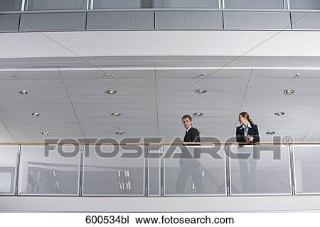 female executive looking at colleague with carry-on View Large Photo Image Stock Image - female executive looking at colleague with carry-on. Fotosearch