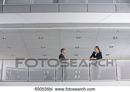 female executive looking at colleague with carry-on View Large Photo Image Stock Image - female executive looking at colleague with carry-on. Fotosearch