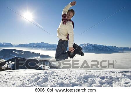 full body portrait of man doing jump on mountain top View Large Photo Image Stock Image - full body portrait of man doing jump on mountain top. Fotosearch
