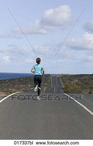 full body portrait of woman jogging along empty road View Large Photo Image Stock Image - full body portrait of woman jogging along empty road. Fotosearch
