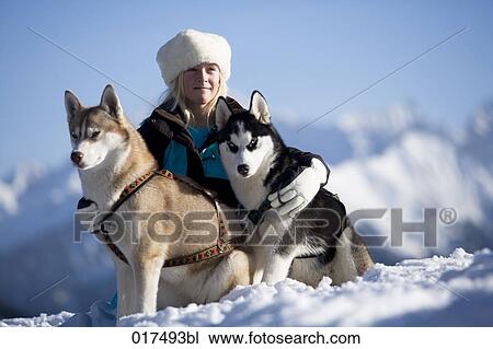 girl posing for a portrait with her two huskies in the mountains View Large Photo Image Stock Image - girl posing for a portrait with her two huskies in the mountains. Fotosearch