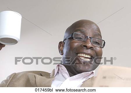 happy black businessman reading newspaper View Large Photo Image Stock Image - happy black businessman reading newspaper. Fotosearch