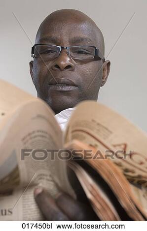 headshot of black business man reading financial newspaper View Large Photo Image Stock Image - headshot of black business man reading financial newspaper. Fotosearch