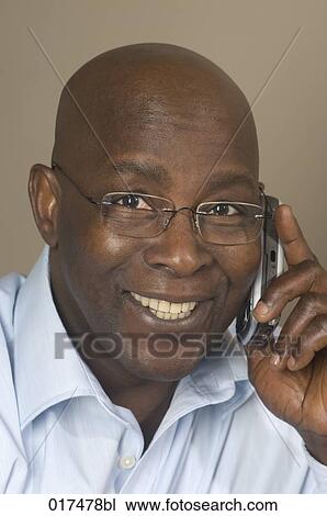 headshot of black businessman talking on mobile phone View Large Photo Image Stock Image - headshot of black businessman talking on mobile phone. Fotosearch