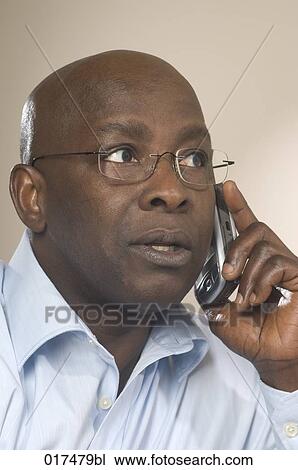headshot of black businessman talking on mobile phone View Large Photo Image Stock Image - headshot of black businessman talking on mobile phone. Fotosearch