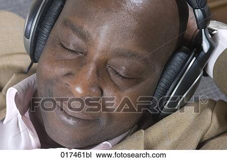 headshot of black businessman with earphones listening to music View Large Photo Image Stock Image - headshot of black businessman with earphones listening to music . Fotosearch