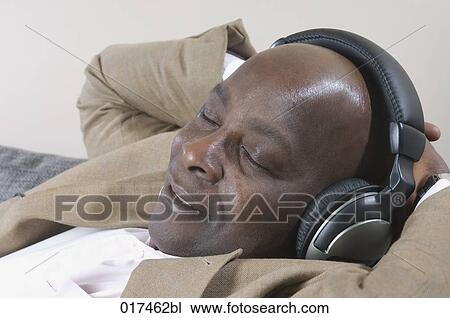 headshot of black businessman with earphones listening to music View Large Photo Image Stock Image - headshot of black businessman with earphones listening to music . Fotosearch