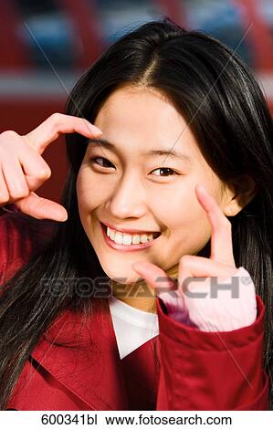 headshot of japanese woman doing the gesture of photographing View Large Photo Image Stock Image - headshot of japanese woman doing the gesture of photographing. Fotosearch