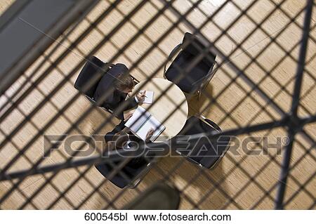 high angle view of group of business people sitting around conference table View Large Photo Image Stock Image - high angle view of group of business people sitting around conference table. Fotosearch