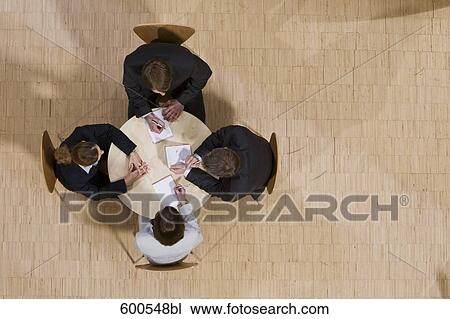 high angle view of group of business people sitting around conference table View Large Photo Image Stock Image - high angle view of group of business people sitting around conference table. Fotosearch