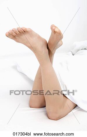 legs of young woman relaxing in bed View Large Photo Image Stock Image - legs of young woman relaxing in bed. Fotosearch