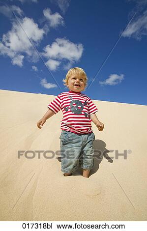 little boy standing on sand dune View Large Photo Image Stock Image - little boy standing on sand dune. Fotosearch