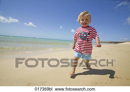 little boy walking on beach View Large Photo Image Stock Image - little boy walking on beach. Fotosearch