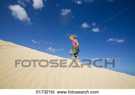 little boy walking up sand dune View Large Photo Image Stock Image - little boy walking up sand dune. Fotosearch
