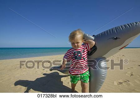 little boy with inflatable on beach View Large Photo Image Stock Image - little boy with inflatable on beach. Fotosearch