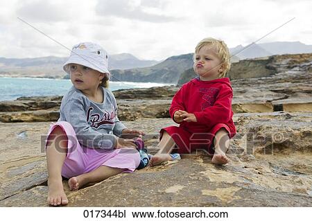 little girl and her brother sitting on rocks View Large Photo Image Stock Image - little girl and her brother sitting on rocks. Fotosearch