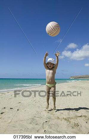little girl playing with ball on beach View Large Photo Image Stock Image - little girl playing with ball on beach. Fotosearch