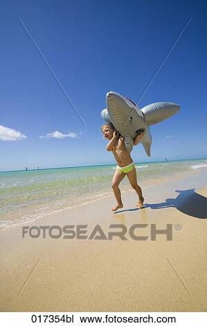 little girl running along beach carrying inflatable shark View Large Photo Image Stock Image - little girl running along beach carrying inflatable shark. Fotosearch