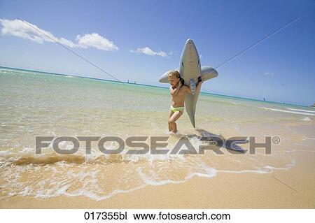 little girl running along beach carrying inflatable shark View Large Photo Image Stock Image - little girl running along beach carrying inflatable shark. Fotosearch