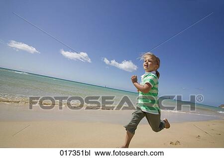 little girl running along sandy beach View Large Photo Image Stock Image - little girl running along sandy beach. Fotosearch