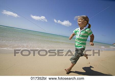 little girl running along sandy beach View Large Photo Image Stock Image - little girl running along sandy beach. Fotosearch