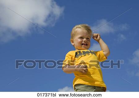 Stock Image - low angle portrait of little boy. Fotosearch