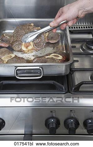 pieces of roasted meat in silver pot on stove View Large Photo Image Stock Image - pieces of roasted meat in silver pot on stove. Fotosearch
