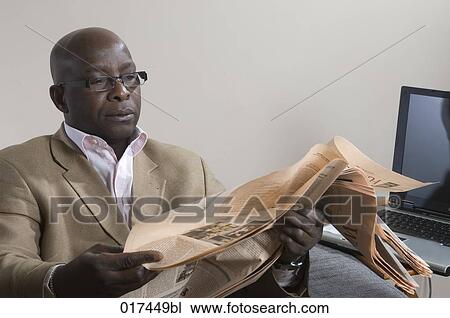 portrait of black business man reading financial newspaper View Large Photo Image Stock Image - portrait of black business man reading financial newspaper. Fotosearch