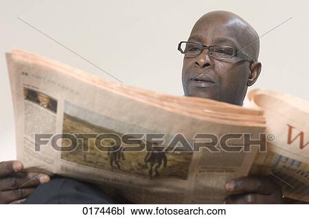 portrait of black businessman reading newspaper View Large Photo Image Stock Image - portrait of black businessman reading newspaper. Fotosearch