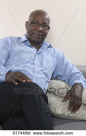 portrait of black businessman sitting on sofa View Large Photo Image Stock Image - portrait of black businessman sitting on sofa. Fotosearch