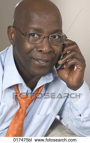 portrait of black businessman talking on mobile phone View Large Photo Image Stock Image - portrait of black businessman talking on mobile phone. Fotosearch