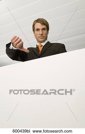 Stock Image - portrait of businessman doing the tumbs down sign. Fotosearch