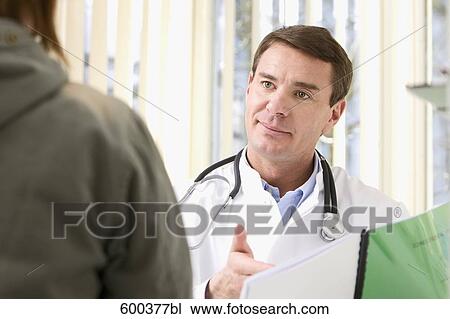 Stock Image - portrait of doctor talking to patient. Fotosearch