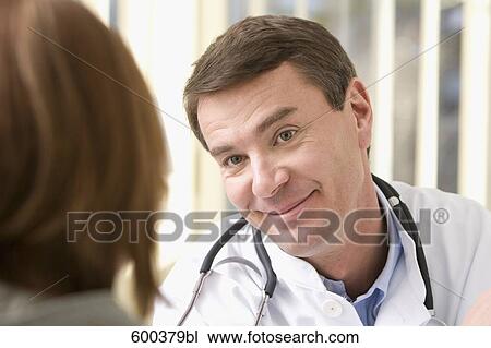 Stock Image - portrait of doctor talking to patient. Fotosearch