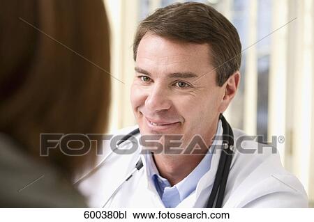 Stock Image - portrait of doctor talking to patient. Fotosearch