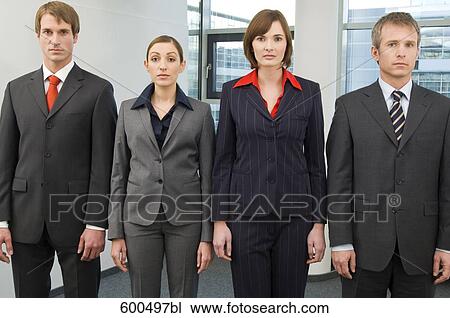 Stock Image - portrait of four business people standing in line. Fotosearch