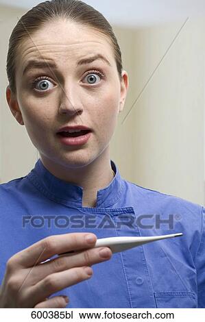 portrait of nurse holding thermometer View Large Photo Image Stock Image - portrait of nurse holding thermometer. Fotosearch