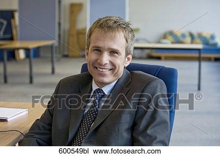 Stock Image - portrait of smiling business in office. Fotosearch