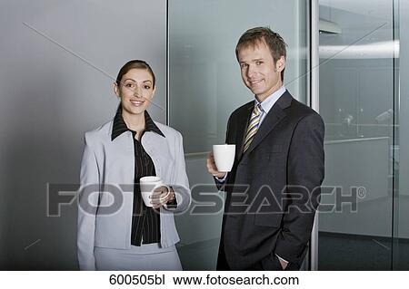 portrait of two executives having coffee break in corridor of office building View Large Photo Image Stock Image - portrait of two executives having coffee break in corridor of office building. Fotosearch