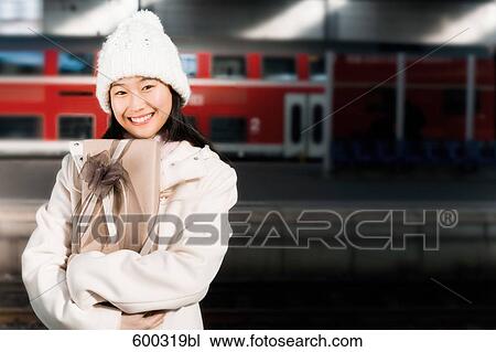 portrait of young japanese woman at train station holding present View Large Photo Image Stock Image - portrait of young japanese woman at train station holding present. Fotosearch