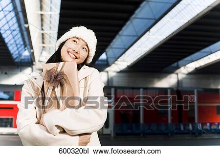 portrait of young japanese woman at train station holding present View Large Photo Image Stock Image - portrait of young japanese woman at train station holding present. Fotosearch