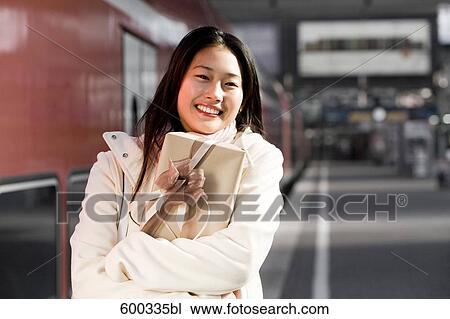 portrait of young japanese woman at train station holding present View Large Photo Image Stock Image - portrait of young japanese woman at train station holding present. Fotosearch