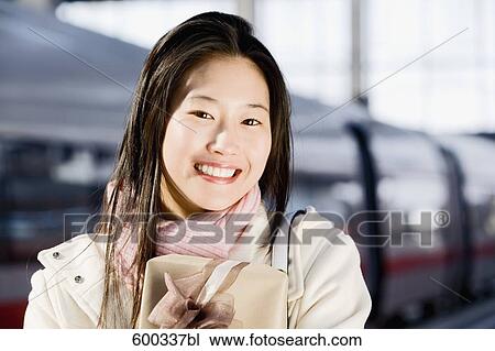 portrait of young japanese woman at train station holding present View Large Photo Image Stock Image - portrait of young japanese woman at train station holding present. Fotosearch